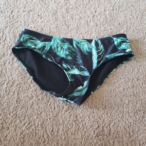 Green leaf foliage on black background bikini bottom cheeky